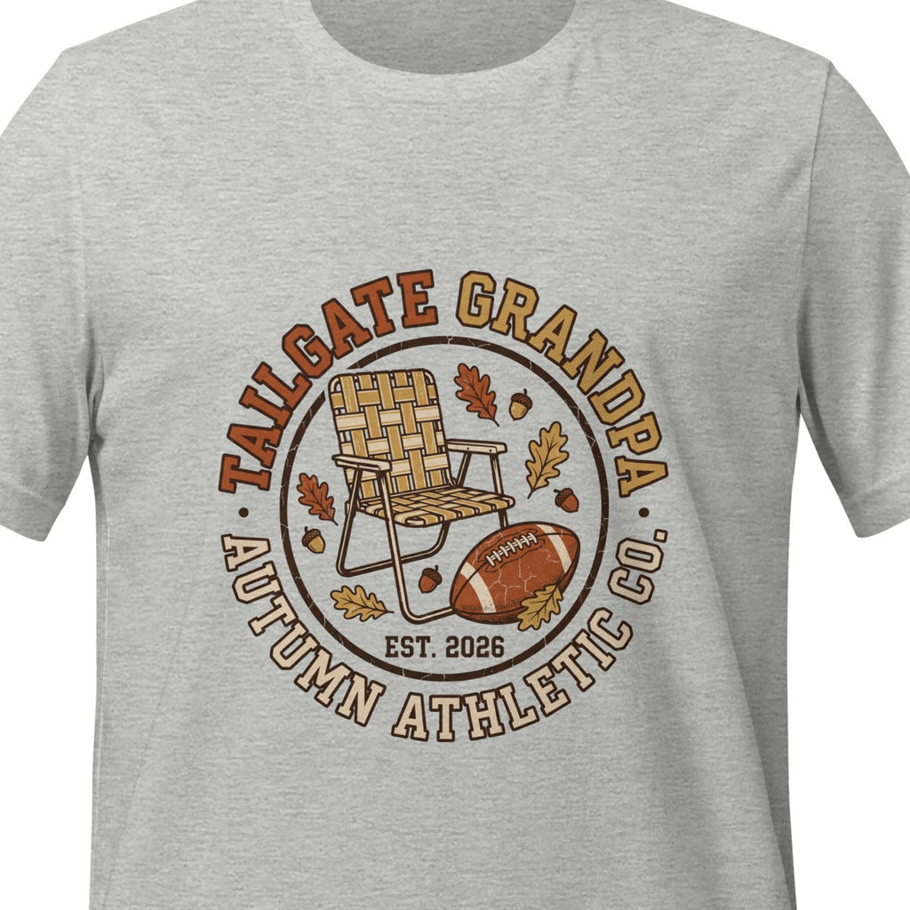 Athletic heather unisex t-shirt printed with a circular badge reading Tailgate Grandpa and Autumn Athletic Co., arched around a folding lawn chair, a football and autumn leaves