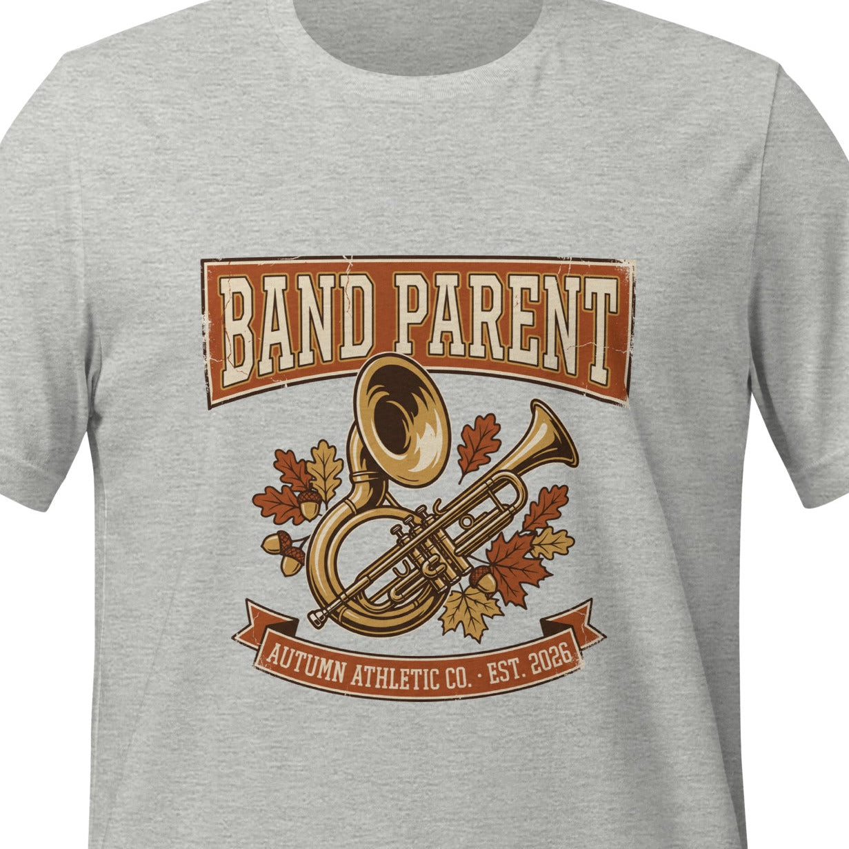 Athletic heather unisex t-shirt printed with a vintage banner reading Band Parent above a marching band tuba and trumpet, surrounded by autumn leaves in rust and gold